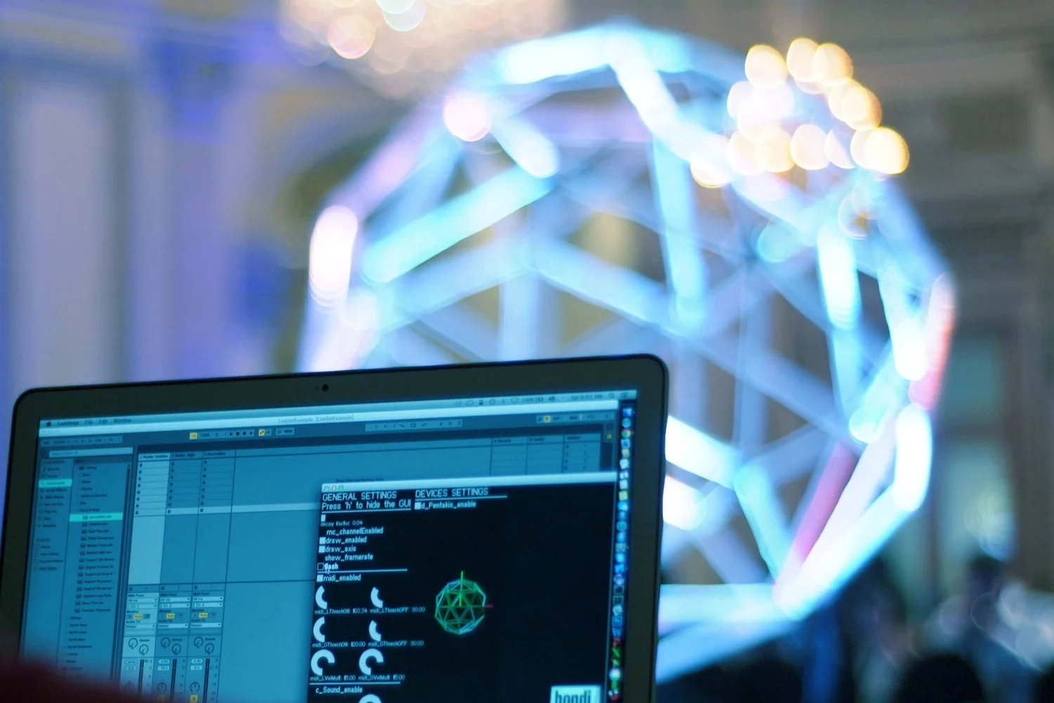 A laptop running the Barcelona software with the illuminated structure behind it.