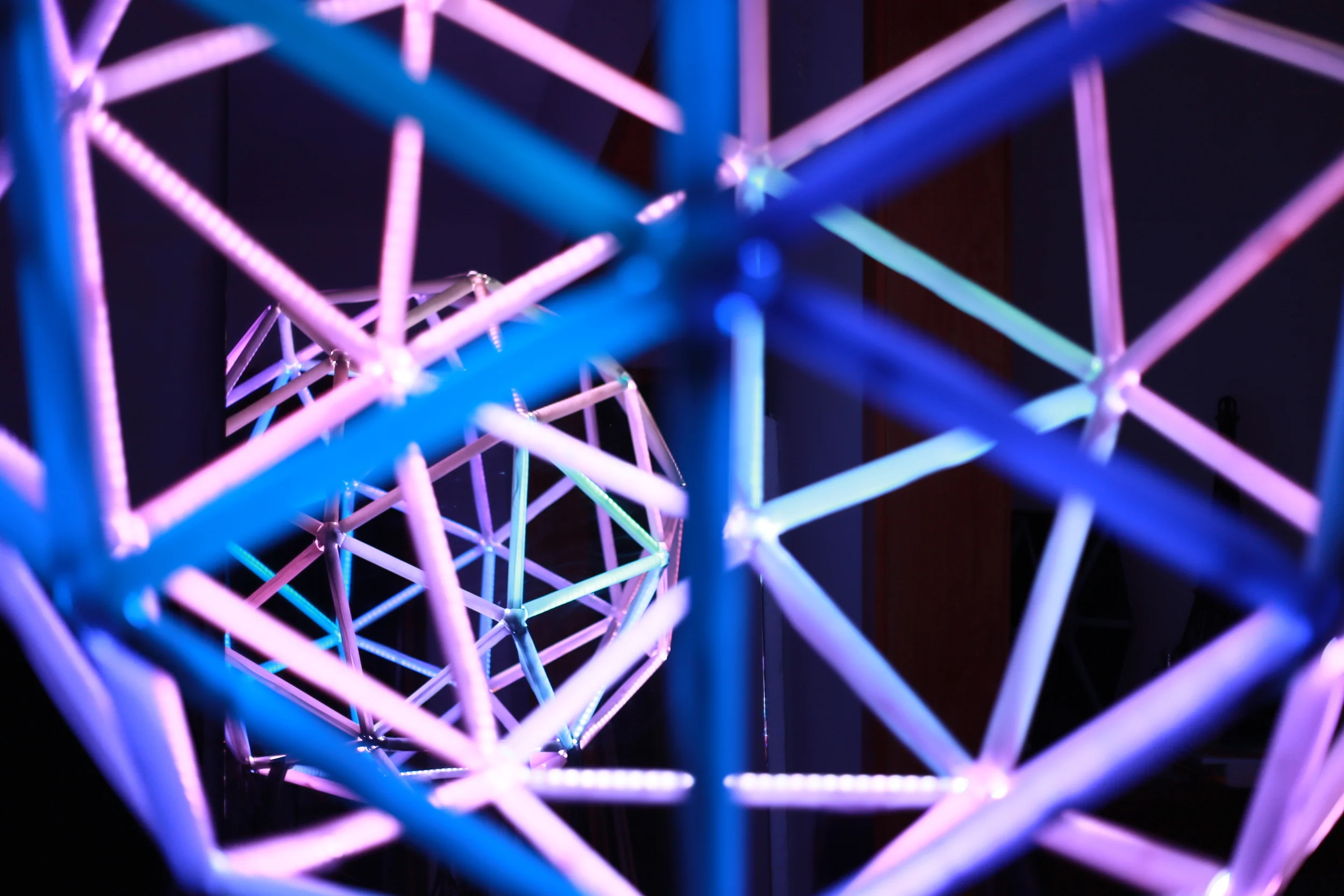 Pink and blue illuminated geometric frames in the Barcelona installation.