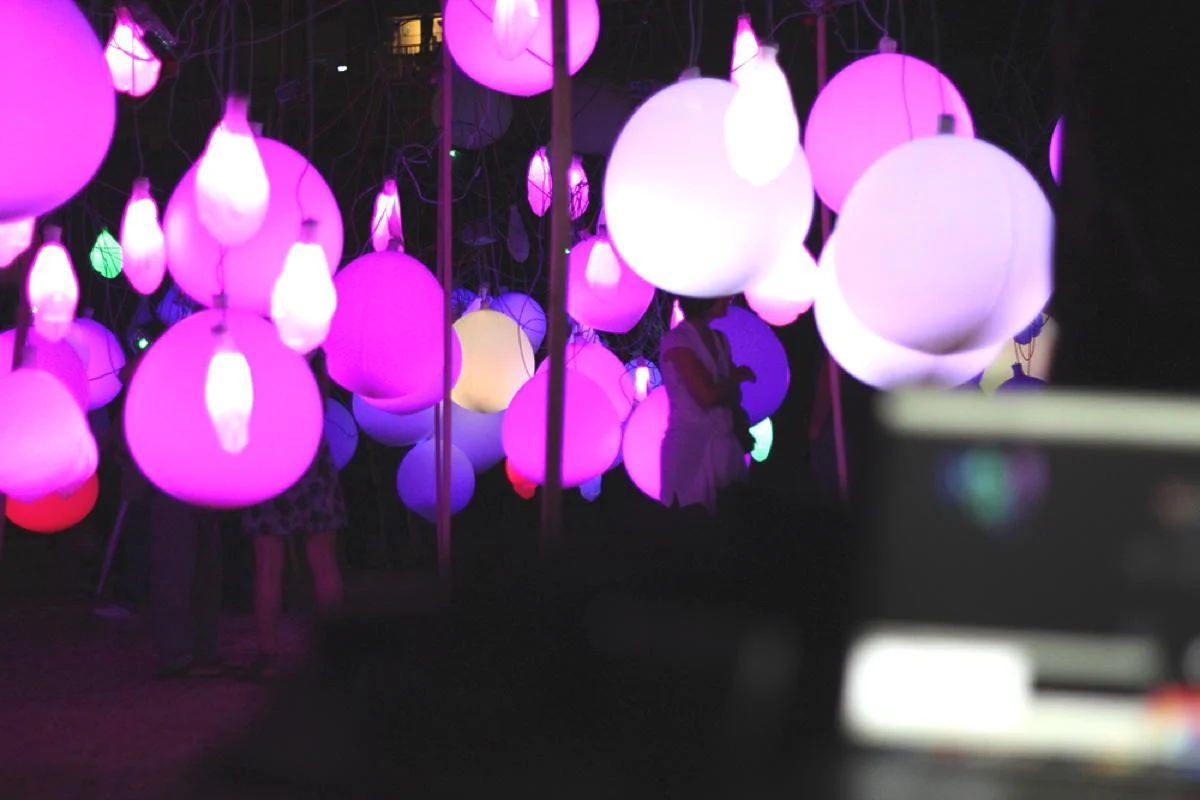 Pink and white illuminated balloons in close-up.