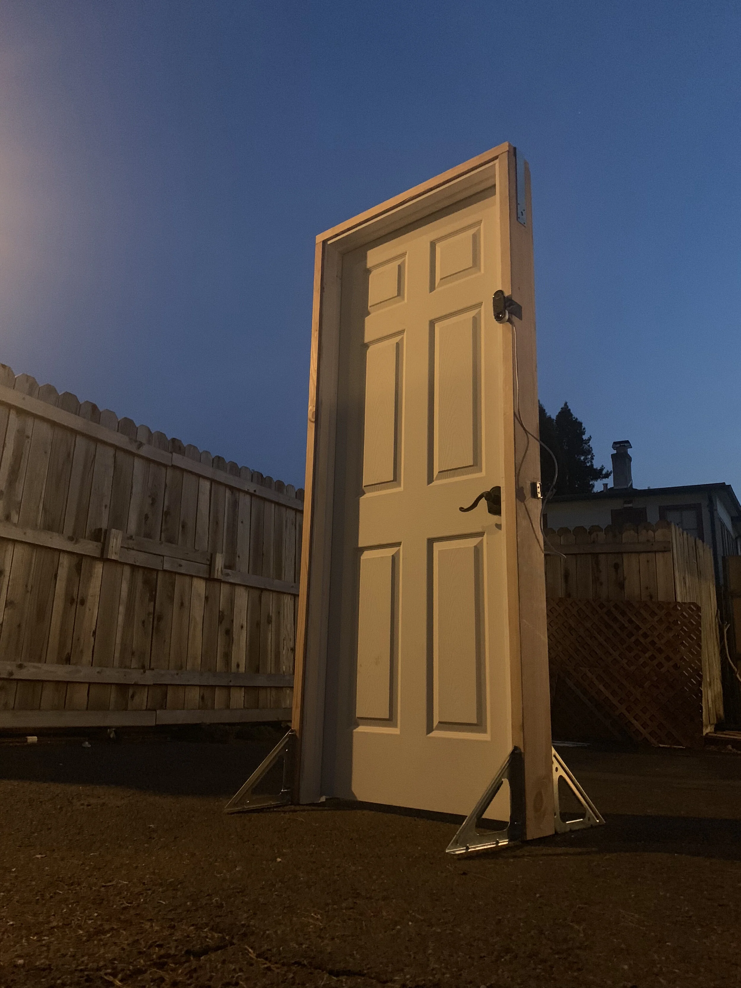 DOOR installation: a participant standing at a door fitted with a camera
