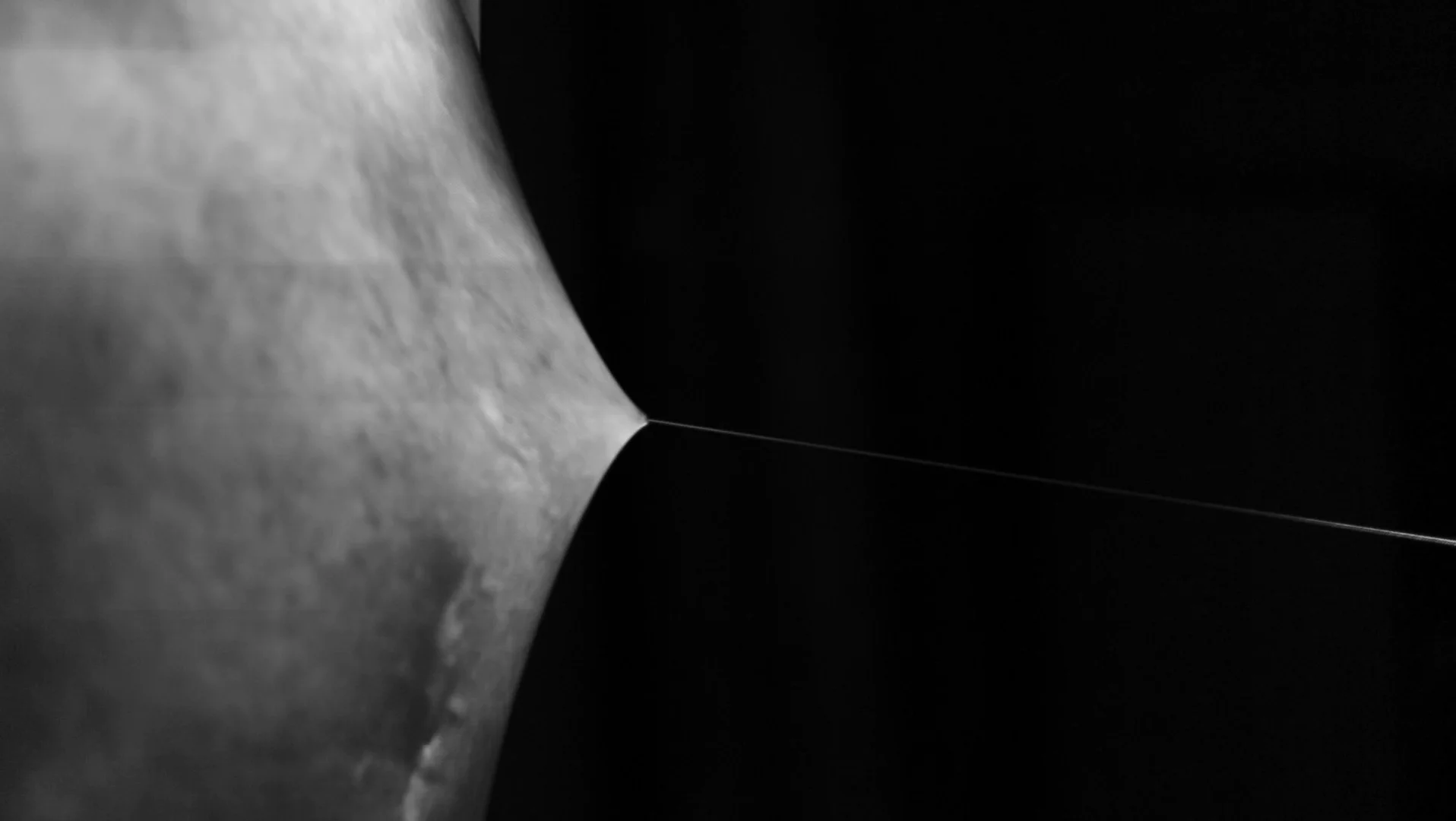 Projected skin on the elastic screen, pulled outwards by a fine cord.