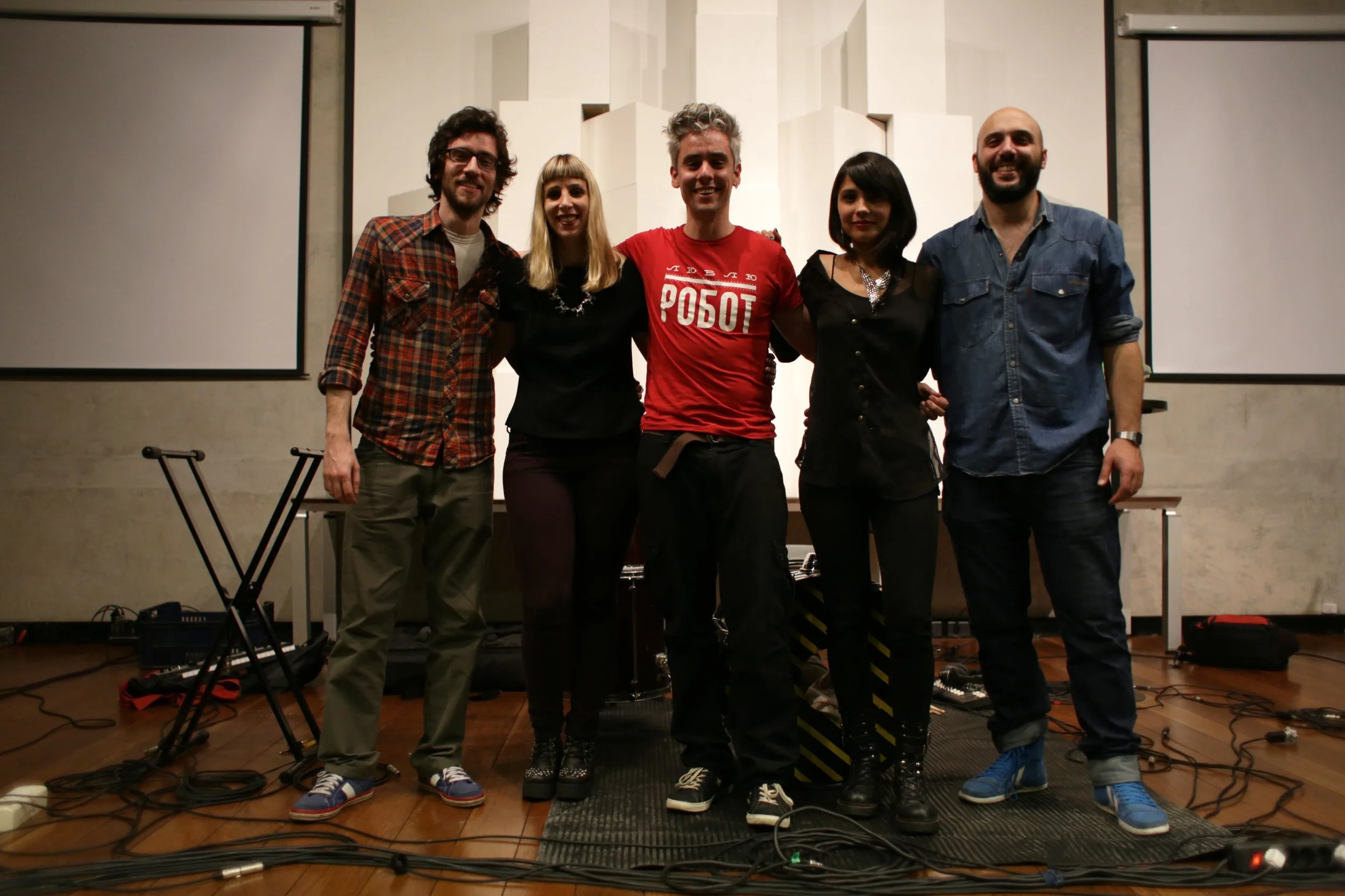 Five members of Lituania Lituania stand together in the performance space.