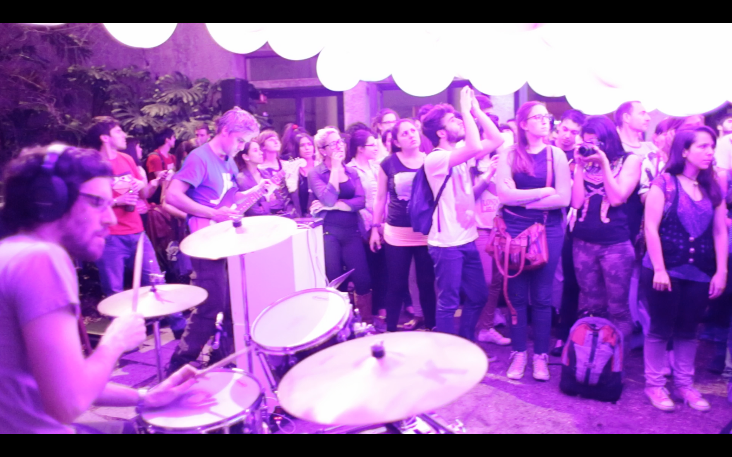 The audience beside percussion instruments and illuminated balloons during the performance.