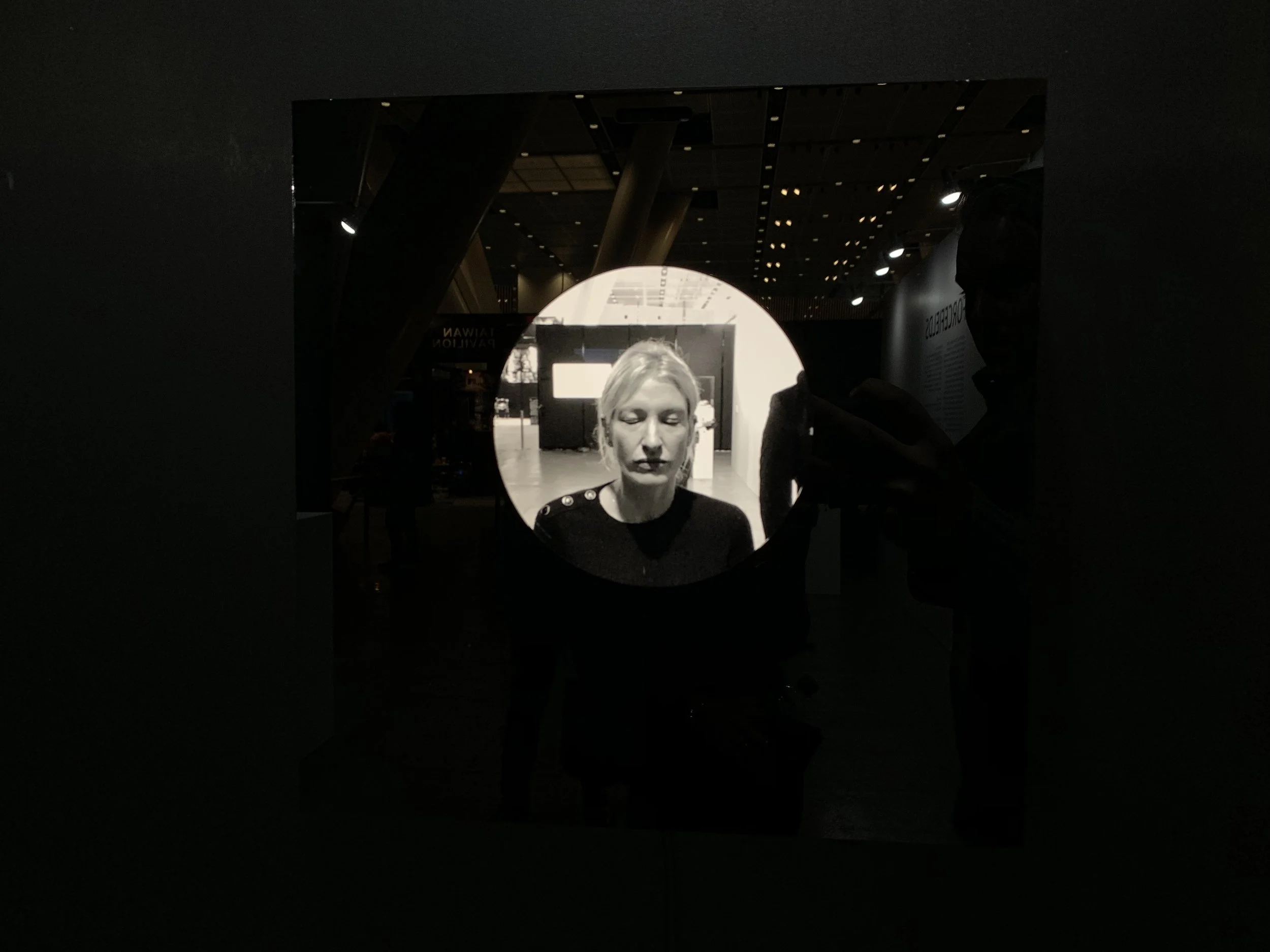 A light-haired closed-eye portrait in the circular display.