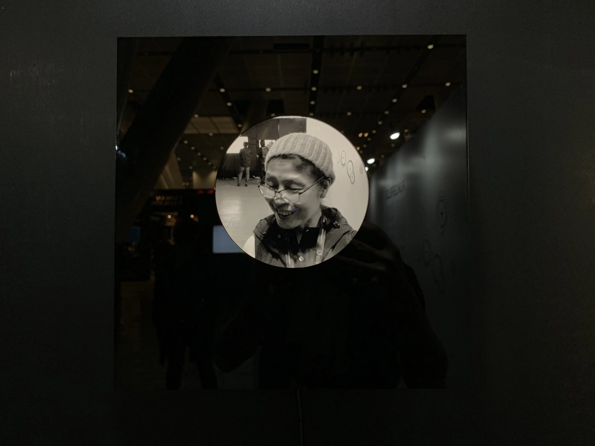 A bearded portrait wearing glasses in the circular display.