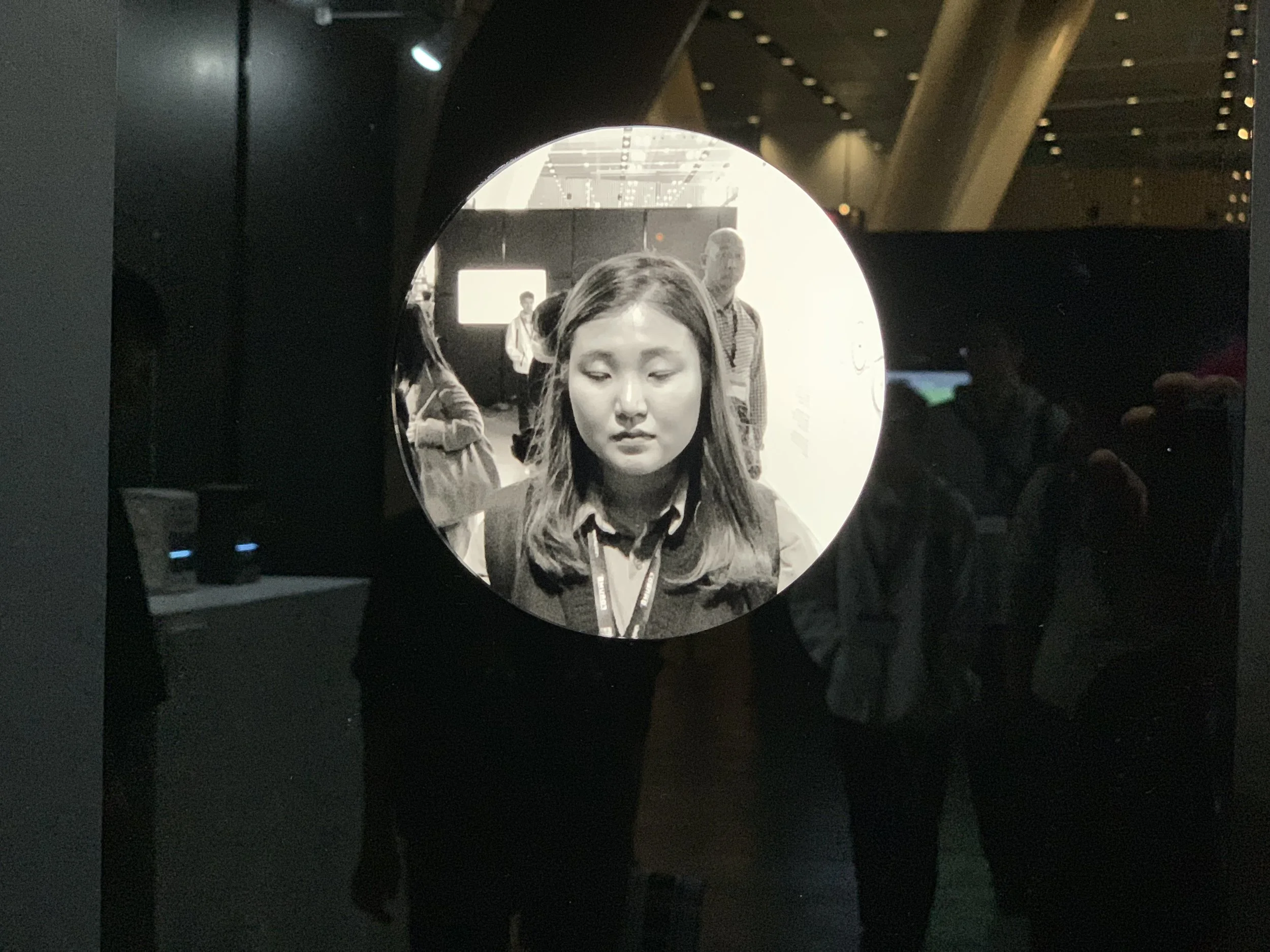 A long-haired closed-eye portrait in the circular display.