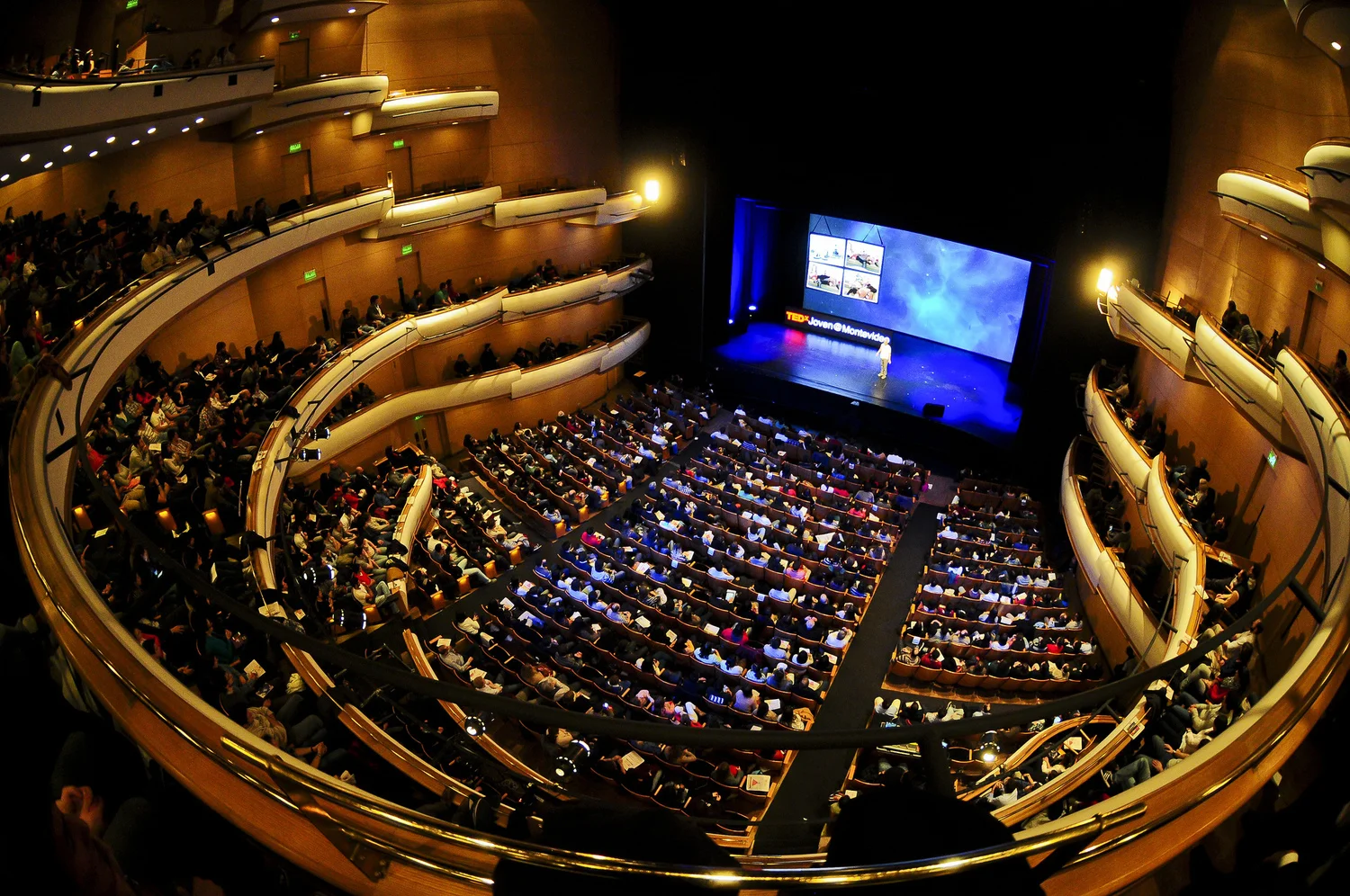 A full auditorium faces the screen and stage at TEDx Montevideo.