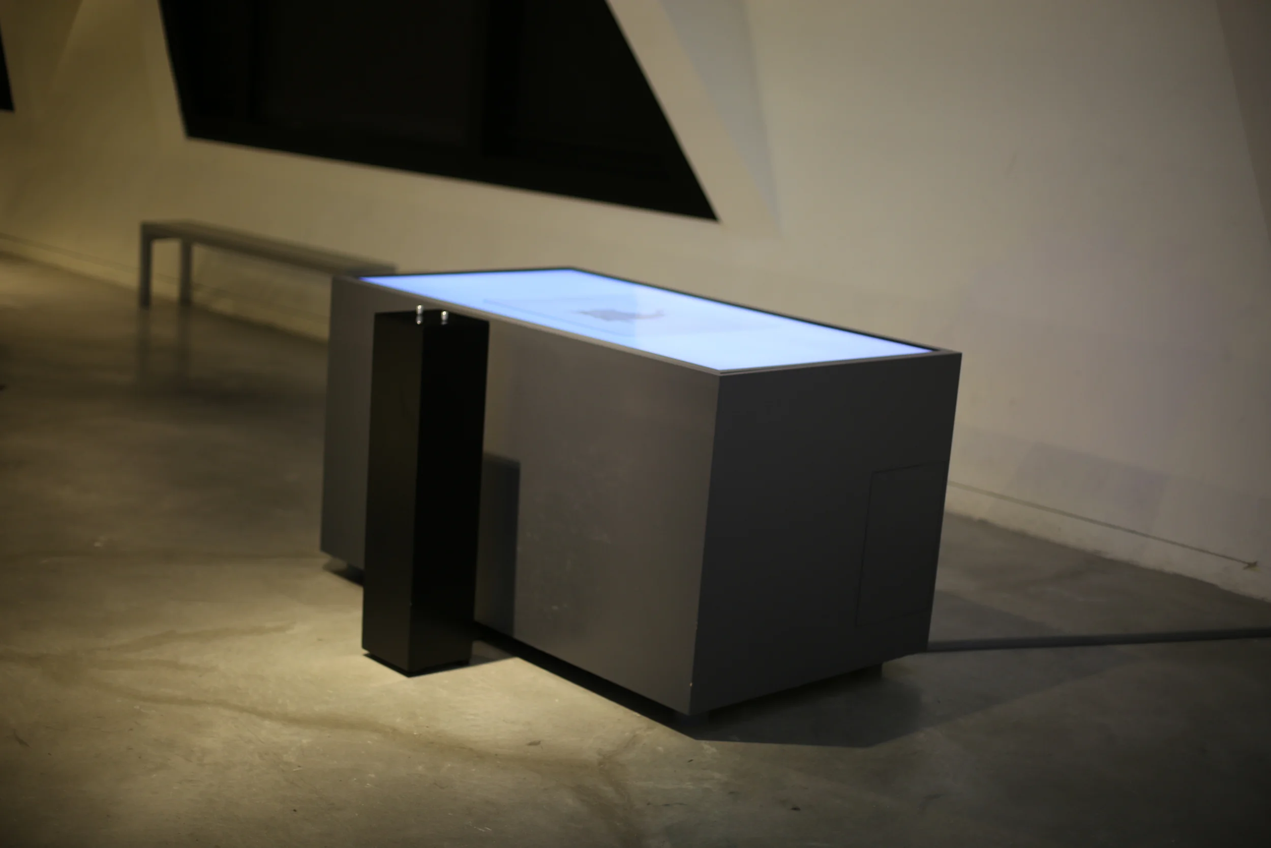 Two Systems installed beneath a triangular wall detail in the gallery.