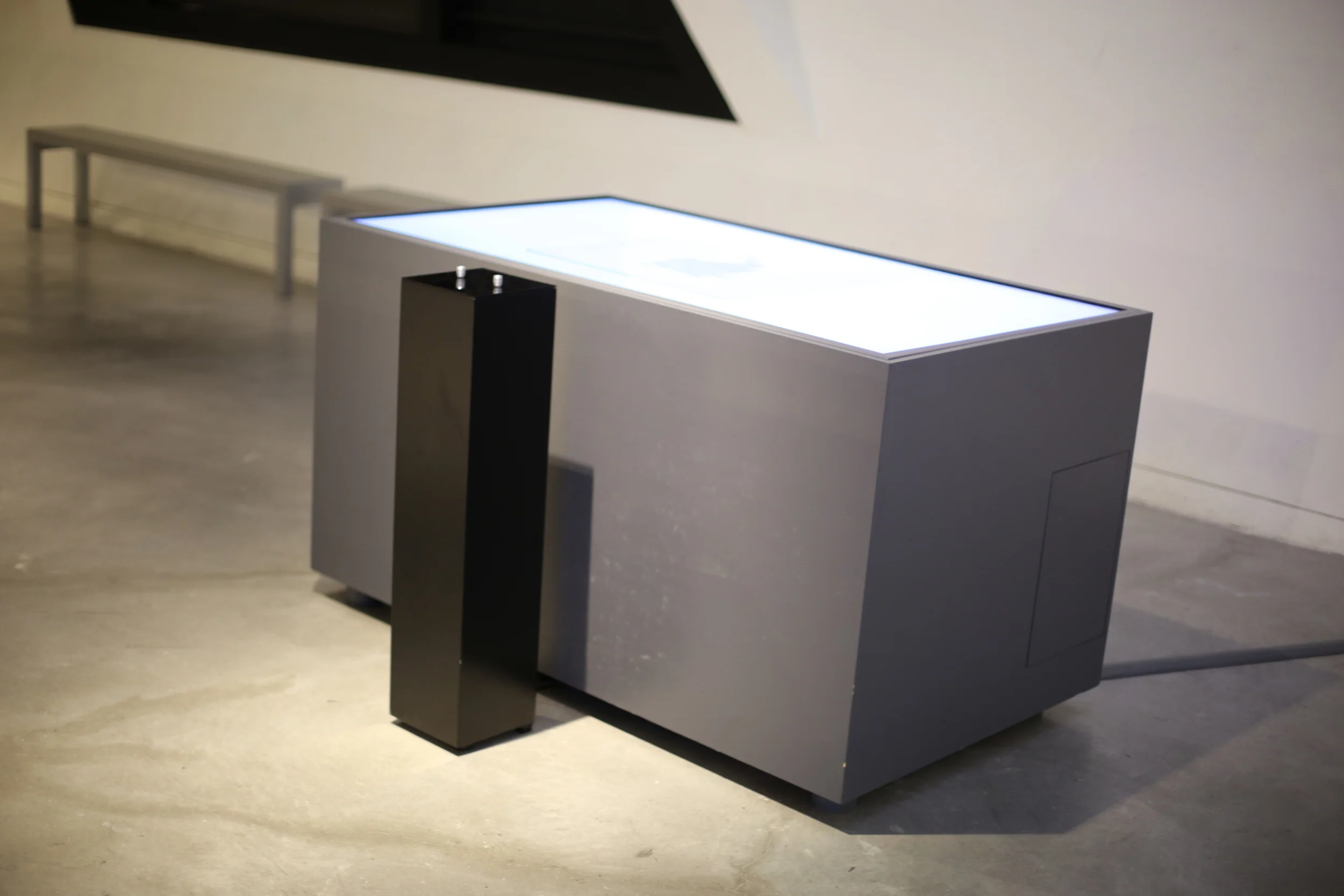 An angled view of the table with its black pedestal in the foreground.